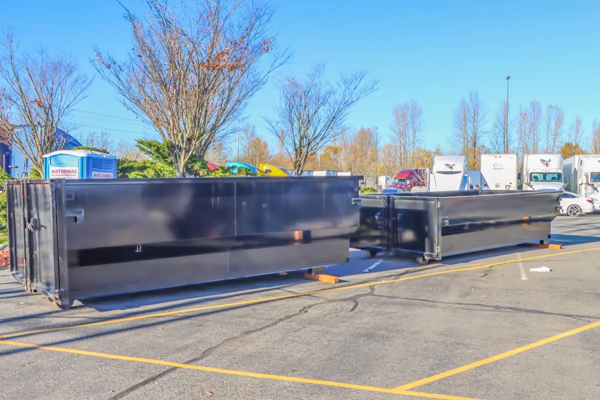 Professional dumpster rental service with roll-off container on residential driveway in Florida City